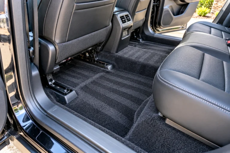 Freshly vacuumed car floor and seat rails after interior detailing